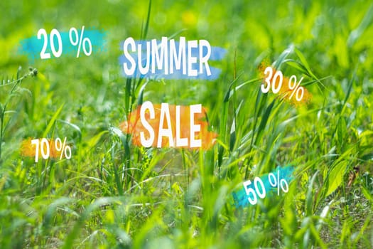 Summer sale advertisement, emblazoned with colorful discount percentages, set against a backdrop of lush green grass