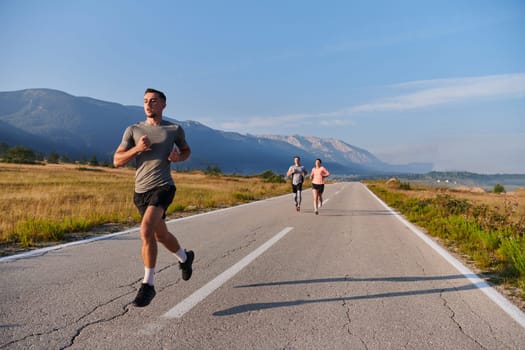 A group of friends maintains a healthy lifestyle by running outdoors on a sunny day, bonding over fitness and enjoying the energizing effects of exercise and nature.