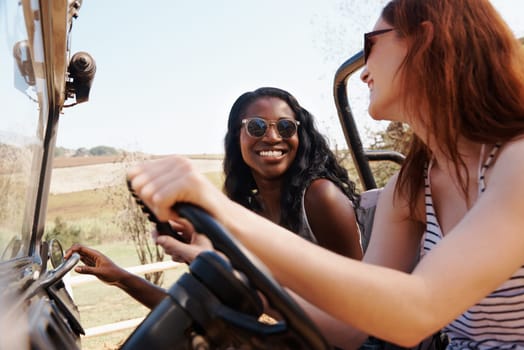 Happy women, bonding and travel on road trip in countryside and sightseeing for adventure in nature. Friends, driving and transportation in offroad vehicle on holiday outdoor in summer in california.