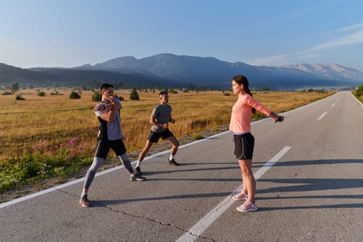 A vibrant and diverse group of athletes engage in stretching and warming up exercises, showcasing their unity and readiness for an invigorating morning run.