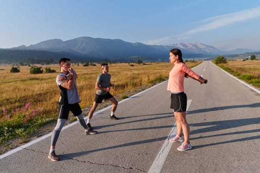 A vibrant and diverse group of athletes engage in stretching and warming up exercises, showcasing their unity and readiness for an invigorating morning run.