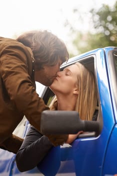 Road, transport and couple kiss in car for greeting, goodbye and love for journey, leaving and commute. Travel, driving and man and woman in vehicle window for bonding, relationship and embrace.