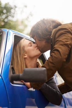 Travel, city and couple kiss in car for greeting, goodbye and love for journey, leaving and commute. Transport, driving and man and woman in vehicle window for bonding, relationship and embrace.