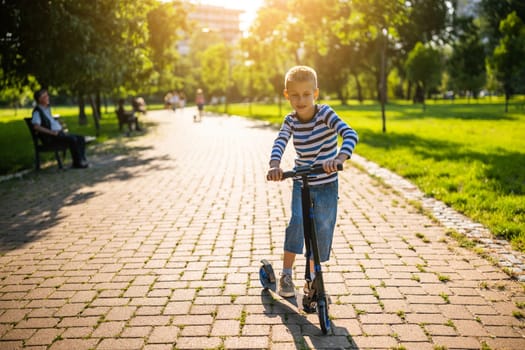 Boy is riding scooter in park on sunny day.