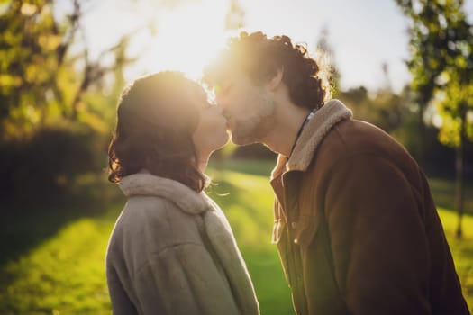 Portrait of happy loving couple in park in sunset.