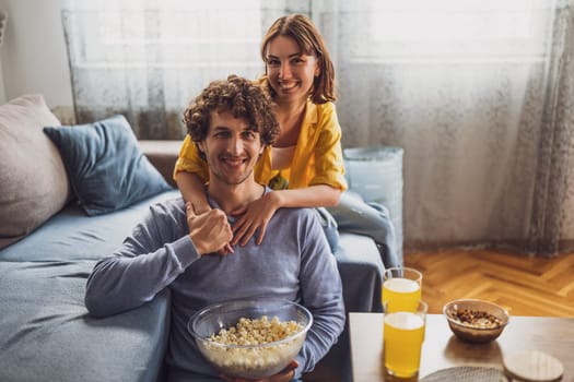 Portrait of young happy couple who is holding hands and smiling.