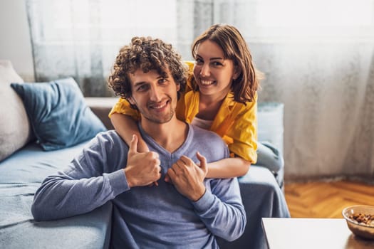 Portrait of young happy couple at home.