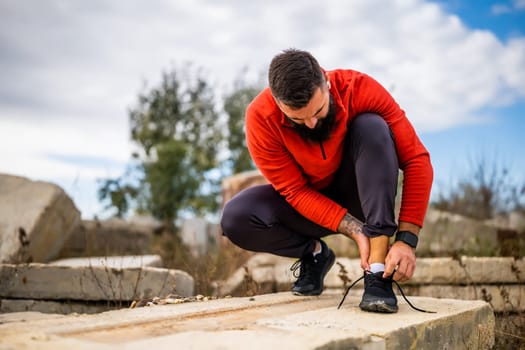 Young man is having pain in ankle while exercising outdoor.