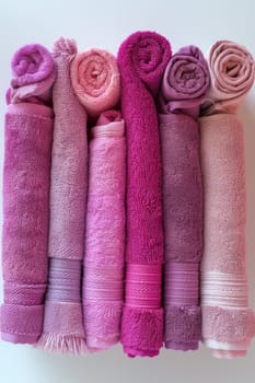 Clean pink and purple towels on a white insulated background.