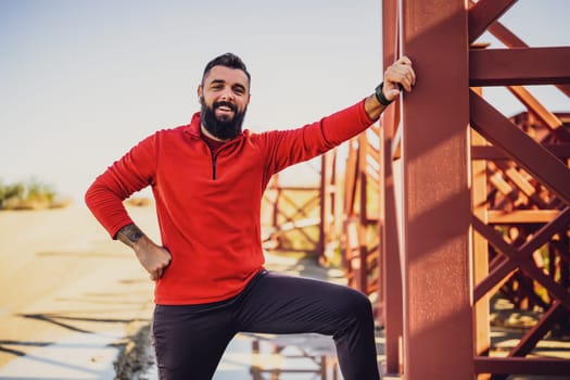 Adult man is ready for exercising outdoor on sunny day.