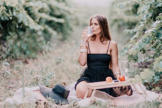 Picnic and wine tasting at sunset in the hills of Italy, Tuscany. Vineyards and open nature in the summer. Romantic dinner, fruit and wine.