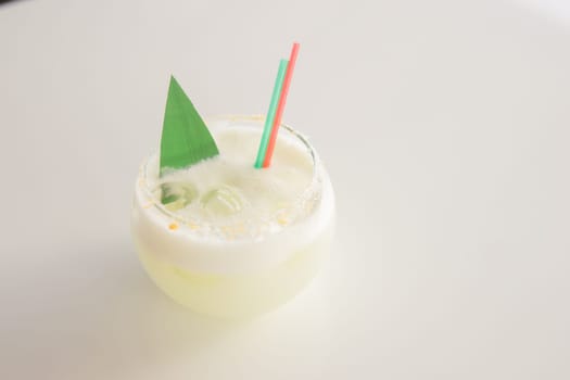 Cold coconut cocktail in a low glass glass. The concept of cold summer drinks.