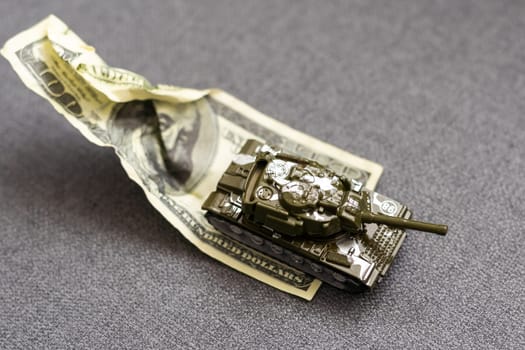 Tank on dollar banknotes. The concept of war costs, military spending, economic crisis. High quality photo