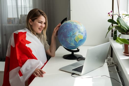 Young female student with Canadian flag and laptop with space for text. High quality photo