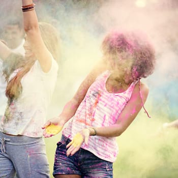 Happy, powder paint and fun with friends outdoor with Holi festival and colorful event with smile. Celebration, love and excited in nature with African people and crazy color dust for party together.