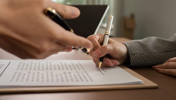 Lawyer and businesswomen discussing and introducing Providing legal advice regarding signing insurance contracts or financial contracts.