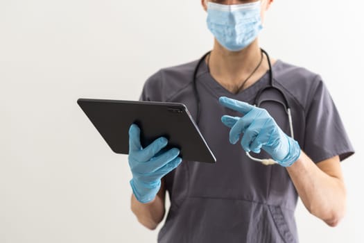 Young male doctor holding tablet with medical health concept.