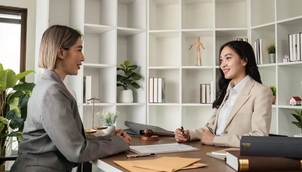 A young lawyer and businesswoman are discussing legal advice on signing a business contract. Insurance or financial contract signing.