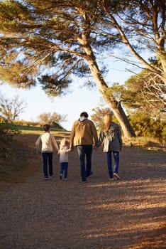 Family, nature and walk for exercise, fitness and bonding for parents and children. Sunset, autumn and forest for hike on holiday in English countryside, mother and father for outdoor activity.