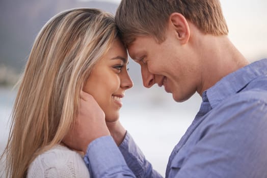 Couple, forehead and touch with smile in outdoor for love with romance in honeymoon, vacation and affection in Australia. Relationship, holiday and happy with bonding for trust, support and care.