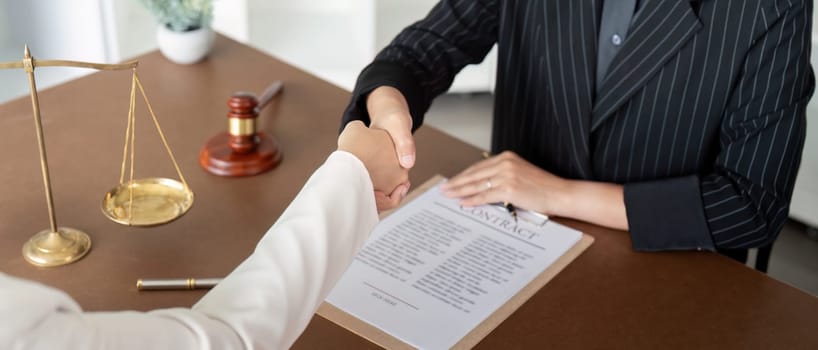 Businesswoman handshake to seal a deal judge female lawyers consultation legal services Consulting in regard to the various contract.
