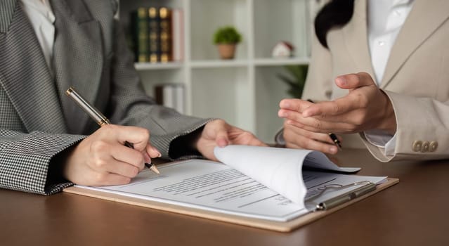 Lawyer and businesswomen discussing and introducing Providing legal advice regarding signing insurance contracts or financial contracts.