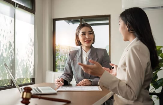 A young lawyer and businesswoman are discussing legal advice on signing a business contract. Insurance or financial contract signing.