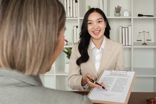 Lawyer and businesswomen discussing and introducing Providing legal advice regarding signing insurance contracts or financial contracts.