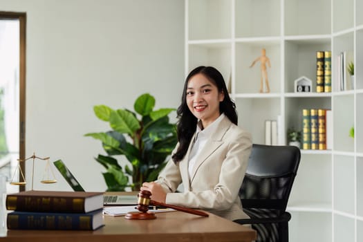 Woman lawyer confident working about ducument at desk and looking at camera.