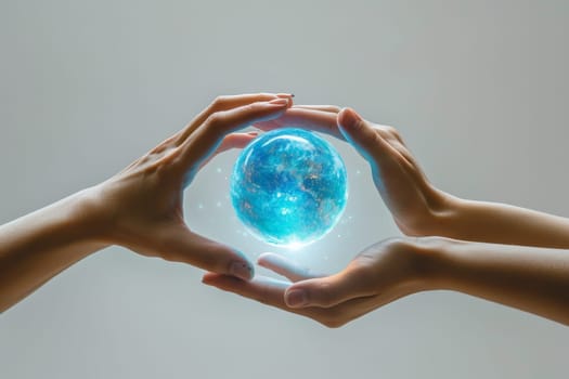 A blue energy ball in the hands of a man on a gray background