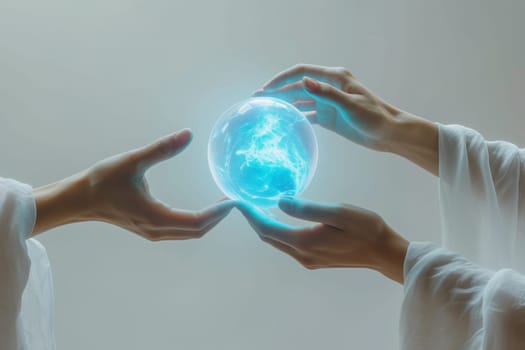 A blue energy ball in the hands of a man on a gray background