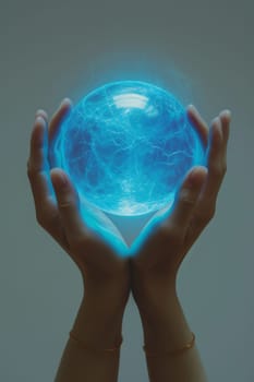 A blue energy ball in the hands of a man on a gray background