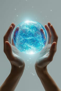 A blue energy ball in the hands of a man on a gray background