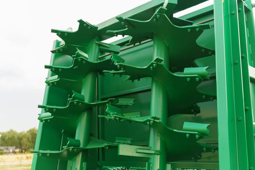 Universal spreader for all types of organic fertilizers, close-up. Used for applying solid organic fertilizers and transporting various agricultural goods in combination with a tractor.