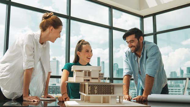 Smart architect team discussion about house design while handsome male worker present idea by using laptop. Group of professional engineer sharing, brainstorming design. Business design. Tracery