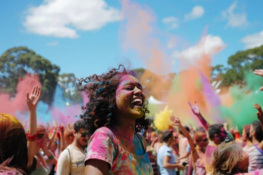 Revelers enjoy a Holi event in Sydney, Australia, captured mid-celebration as clouds of colorful powder fill the air. The festive atmosphere is palpable, with city buildings standing tall in the background.