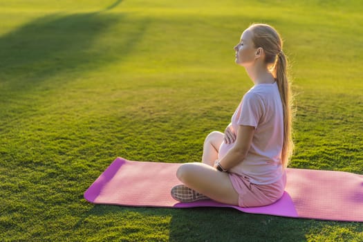 Energetic pregnant woman takes her workout outdoors, using an exercise mat for a refreshing and health-conscious outdoor exercise session.