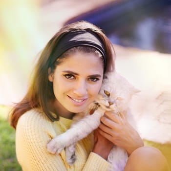 Woman, cat and embrace outdoors in portrait, pet care and smile for affection in backyard or garden. Female person, animal and hug for bonding on vacation or holiday, happy and companion for support.