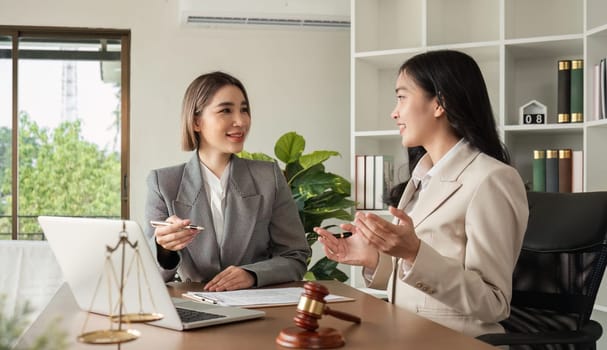 A young lawyer and businesswoman are discussing legal advice on signing a business contract. Insurance or financial contract signing.