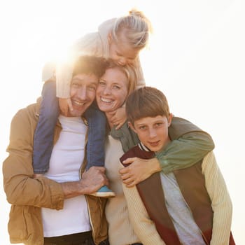 Family, portrait and smile with sunrise, walk and field for morning exercise and bonding. Parents, children and countryside for health, wellness or outdoor adventure at sunset for holiday or vacation.