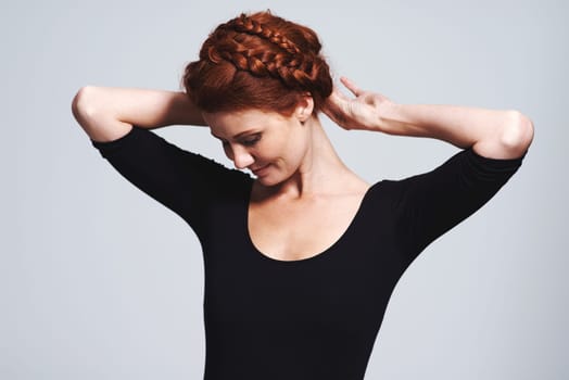 Woman, hair and braid crown for beauty in studio, elegant hairstyle for glamour and redhead on white background. Haircare, shine and texture with model fixing plait, cosmetic care and wellness.