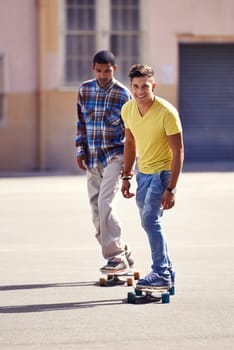 Skateboard, friends and men in street for exercise, training and competition for fun hobby in city. Skate park, fashion and young people in trendy, casual outfit and style for sports and fitness.