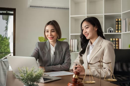 A young lawyer and businesswoman are discussing legal advice on signing a business contract. Insurance or financial contract signing.