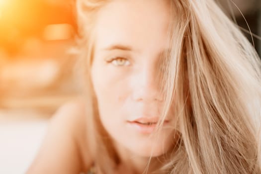 Happy woman portrait in cafe. Boho chic fashion style. Outdoor photo of young happy woman with long hair, sunny weather outdoors sitting in modern cafe