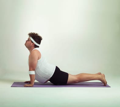 Man, plus size and stretch with mat in studio on white background with exercise or workout and fitness. Healthy, lifestyle and progress with body positivity for self care, wellness and wellbeing.