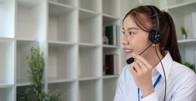 Call center agents wear headphones to talk to customers. Provide consultation via online channels on laptops.