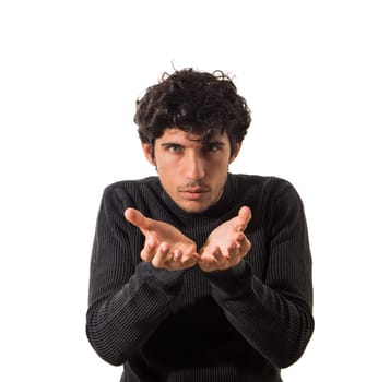 A photo capturing a young man as he makes a gesture with his hands, possibly indicating excitement or emphasis. His expression is focused and determined, highlighting the movement of his hands.