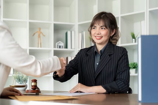 Businesswoman handshake to seal a deal judge female lawyers consultation legal services Consulting in regard to the various contract.