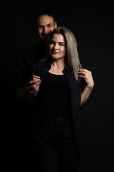 portrait of fashion couple on black background.