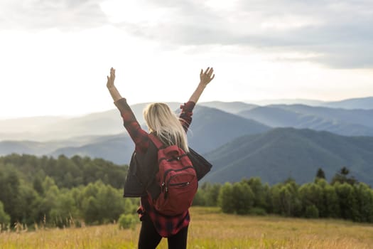 Freedom traveler woman on the top of mountains enjoy a wonderful nature. Yound girl on peak mountain with perfect view mountains. travel concept.